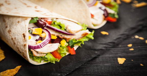 A chicken and vegetable burrito